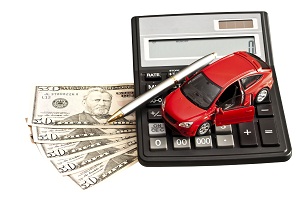 Toy car, money and calculator over white. Concept for buying, re